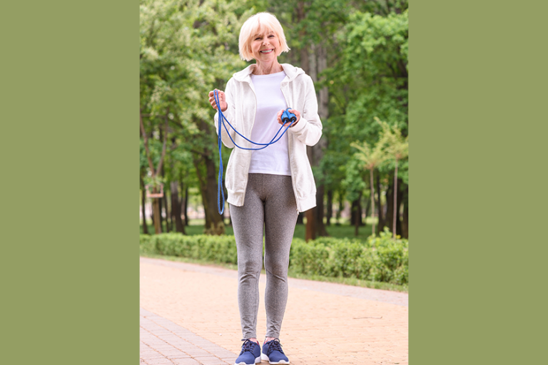 cheerful elderly sportswoman standing