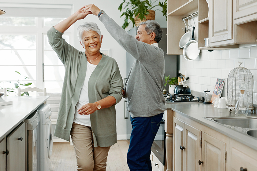 elderly couple dancing love home support holding hands