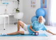 mature physiotherapist training foam roller