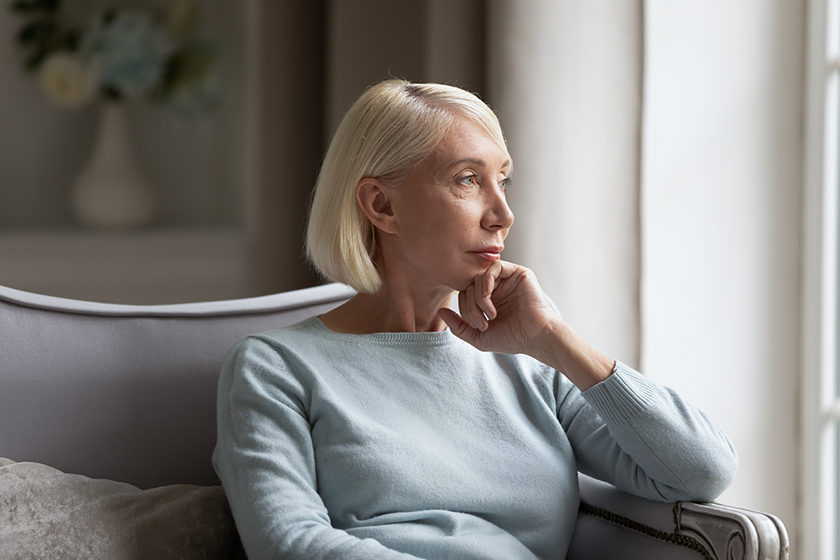 pensive middle aged woman look in distance