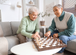 senior female friends playing chess
