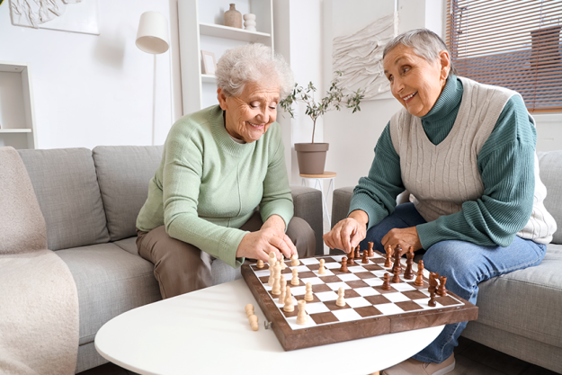senior female friends playing chess