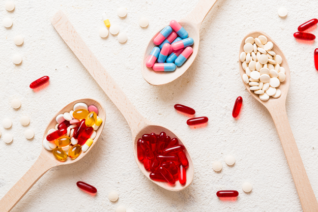 vitamin capsules spoon