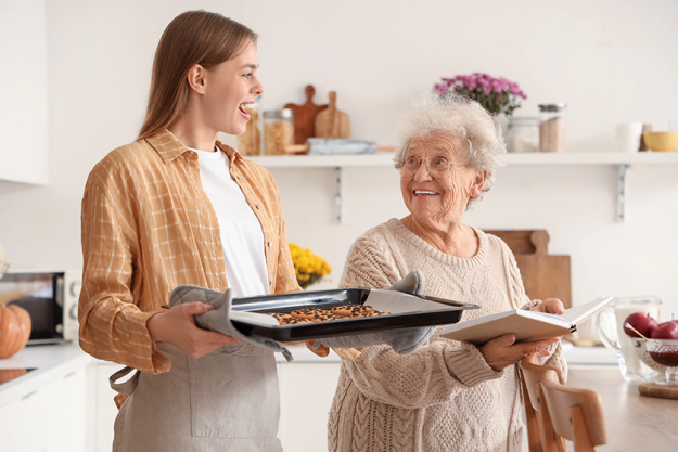 young woman holding baking tray young woman holding baking tray