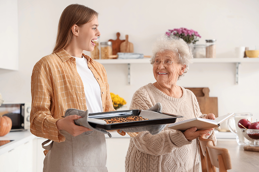 young woman holding baking tray