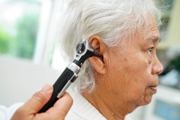 Otolaryngologist or ENT physician doctor examining senior patien Otolaryngologist or ENT physician doctor examining senior patien