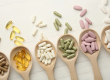 different vitamin capsules spoons