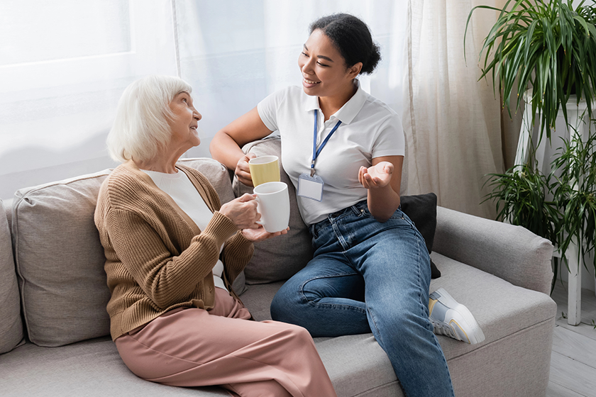 happy multiracial social worker chatting