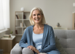 happy pretty senior woman sitting couch
