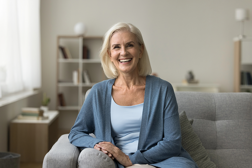 happy pretty senior woman sitting couch