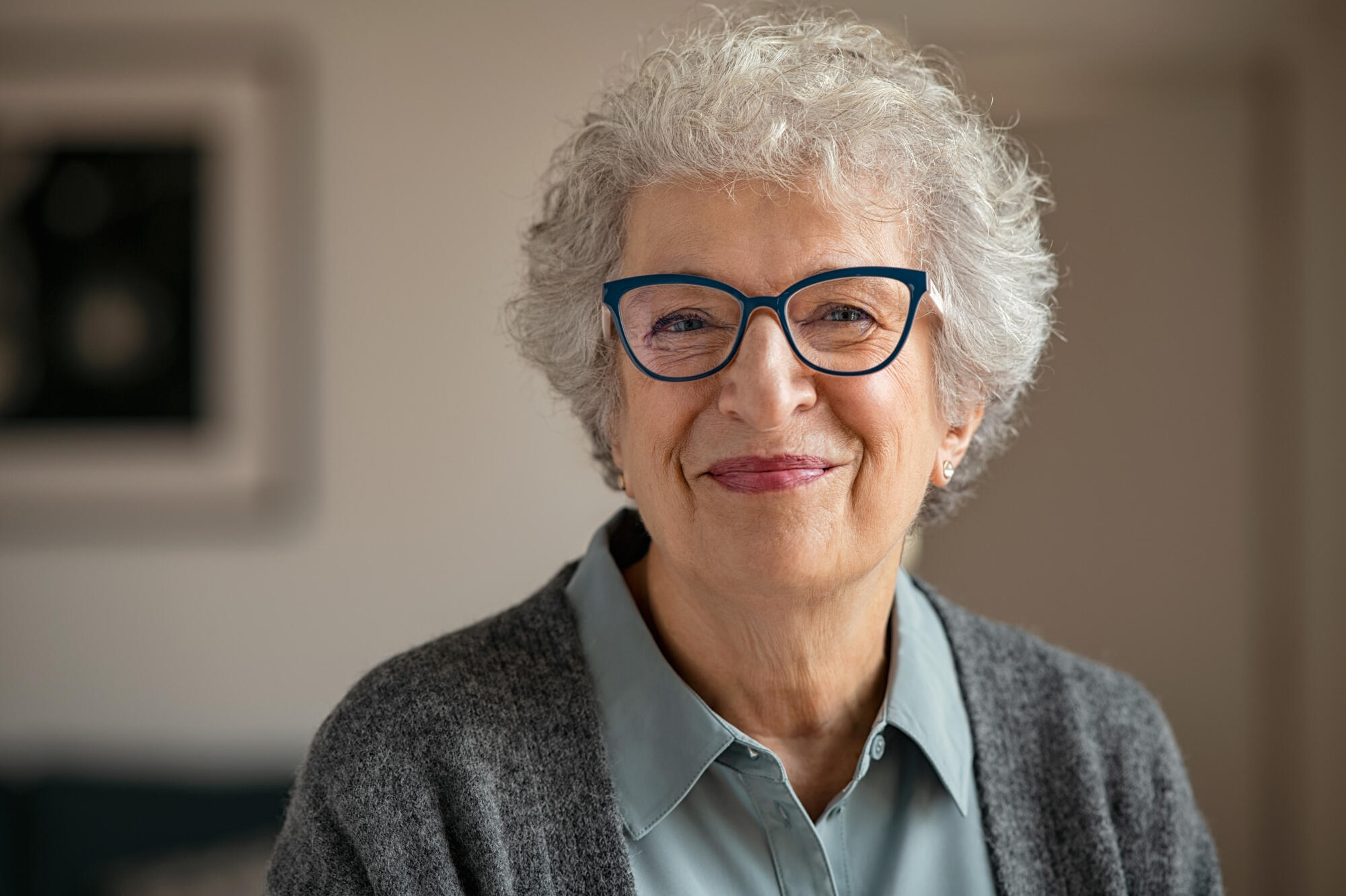Portrait,Of,Happy,Retired,Senior,Woman,Looking,At,Camera,While