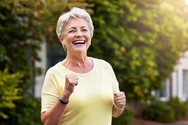 portrait smiling senior woman jogging