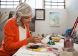 senior woman painting bowl