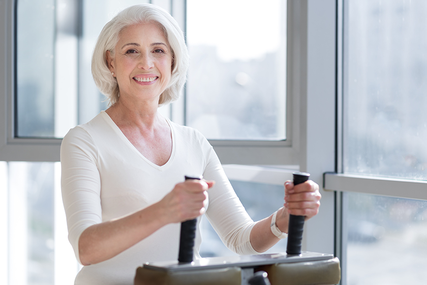 senior woman using gym equipment