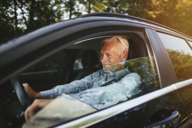 Senior,Man,Smiling,While,Sitting,Alone,In,His,Car,Enjoying Senior,Man,Smiling,While,Sitting,Alone,In,His,Car,Enjoying