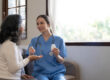 Asian nurse showing health checkup report to grandmather and giv