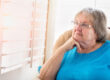 Contemplative Senior Woman Gazing Out of Her Window.