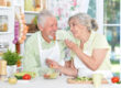 Portrait of a senior couple cooking in kitchen